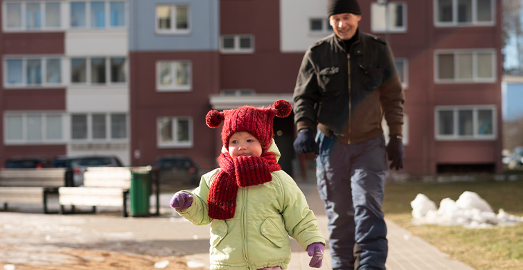 Little child walking with older man